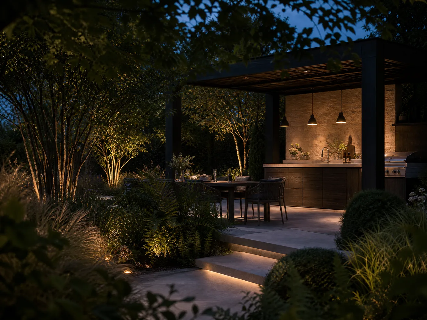 Bespoke outdoor kitchen and dining terrace beneath a dark timber pergola