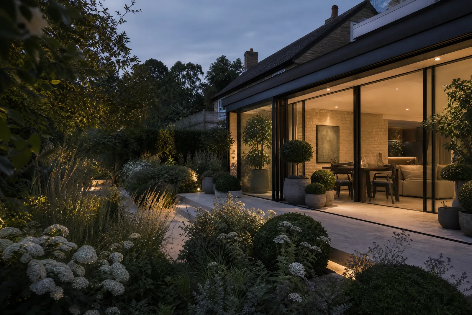 Dark-framed orangery opening into the garden